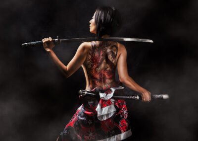 martial art portrait: large tattoo on the back woman with sword