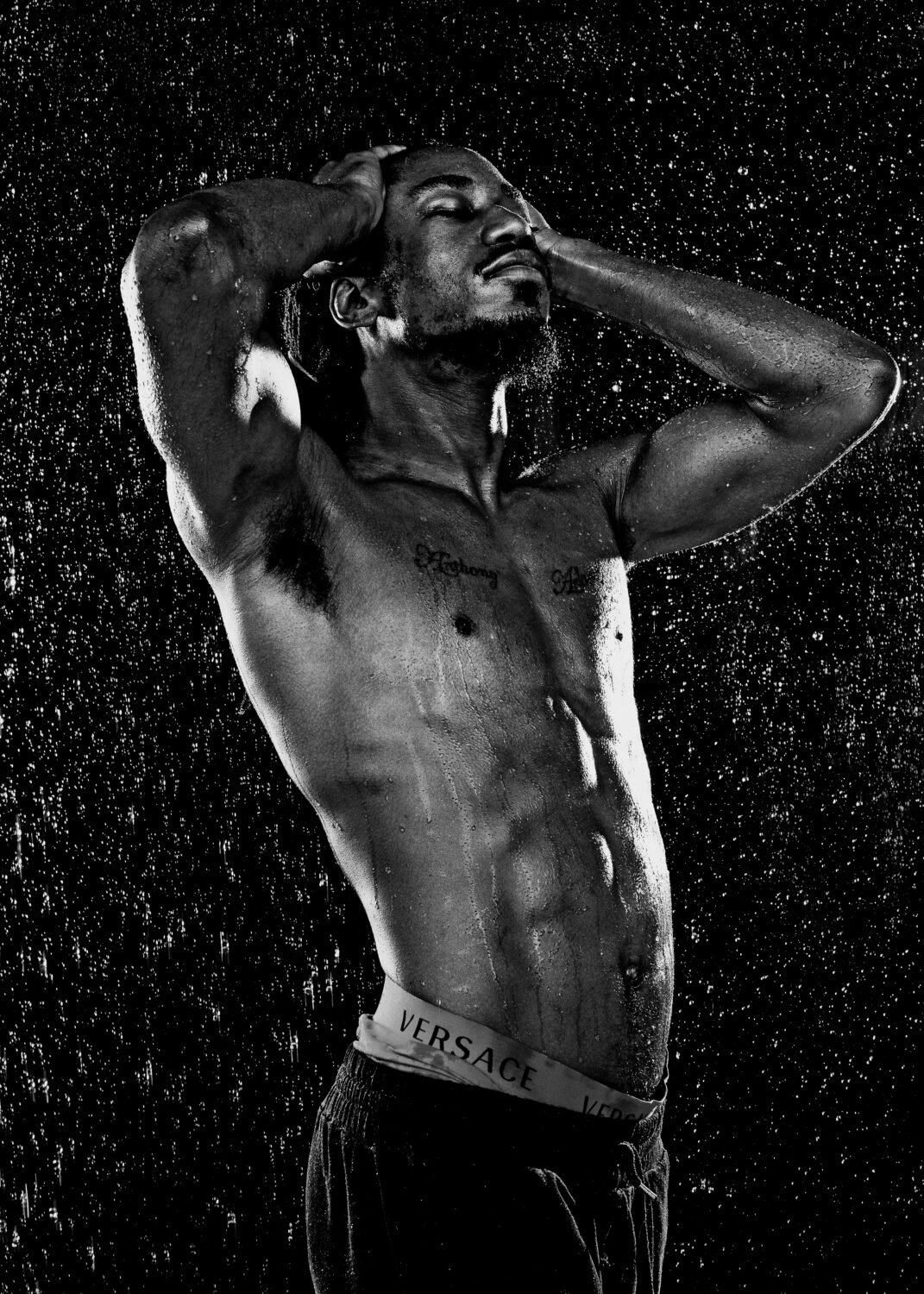 popular bluff fitness photographer: topless fit black male in rain