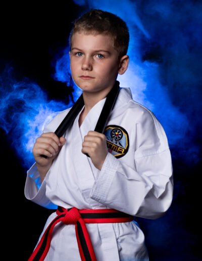 young martial artist with nunchucks with smoke background