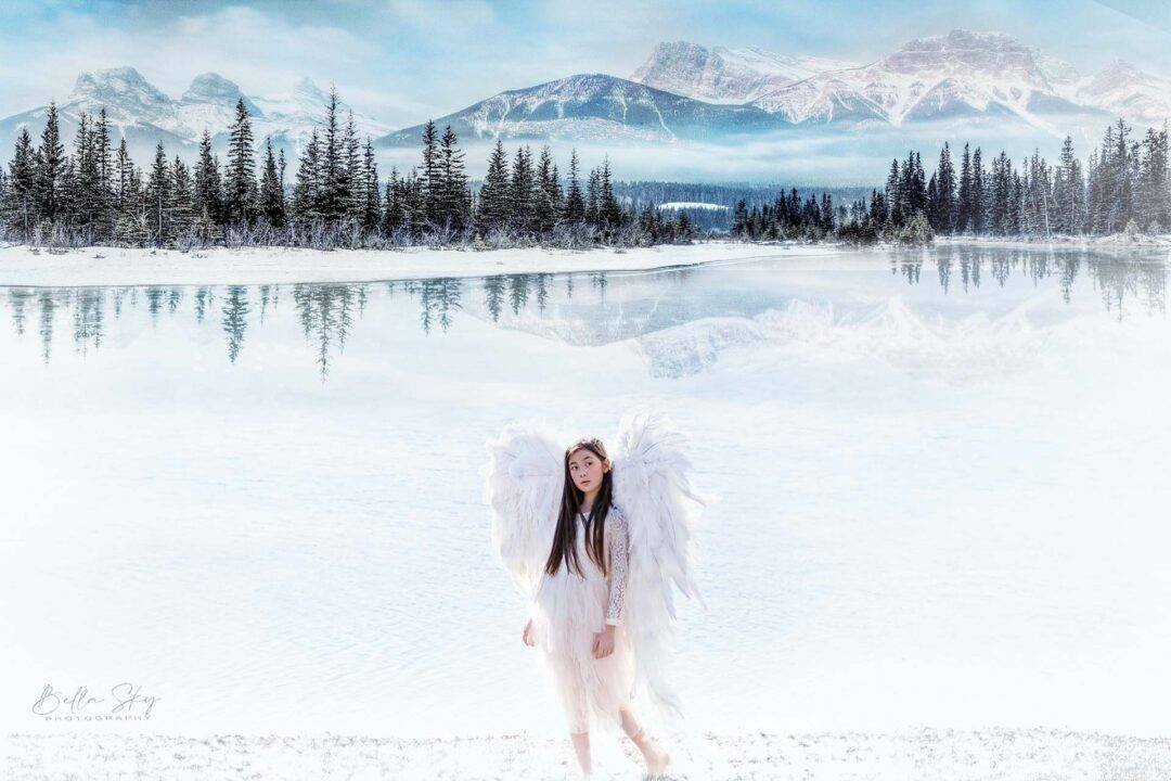 angel by the lake in front of snow mountain